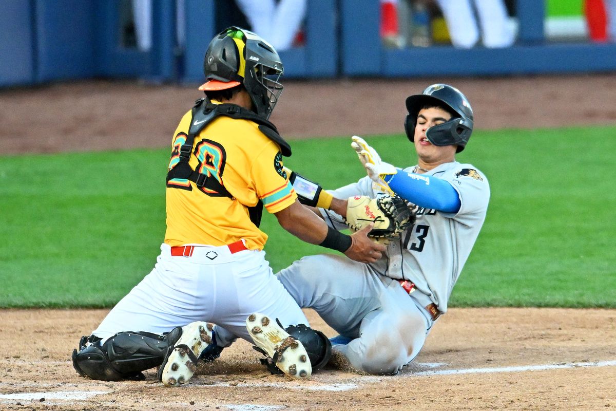 Spokane Indians catcher Juan Castillo applies the tag to Tri-City catcher Juan Flores in the third inning on May 7, 2026 at Avista Stadium.  (James Snook)