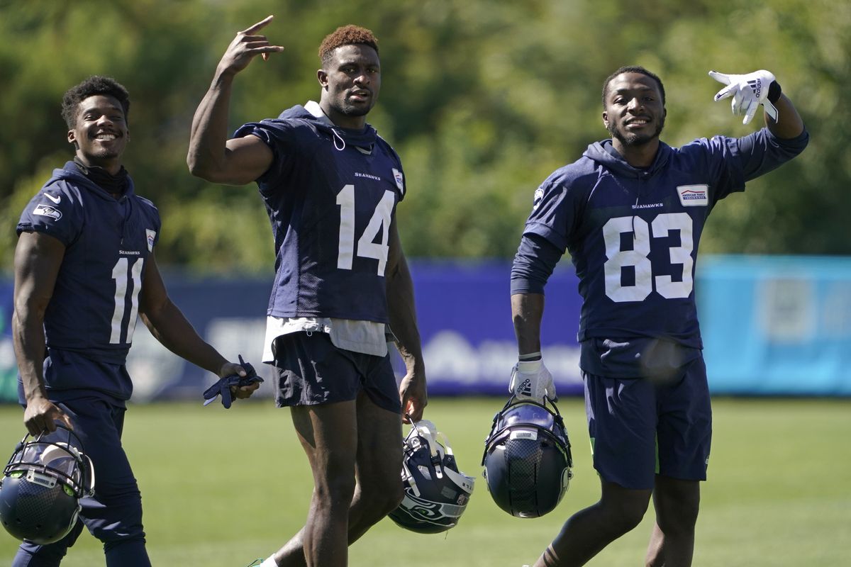 Seattle Seahawks wide receivers Phillip Dorsett II (11), DK Metcalf (14), and David Moore (83), react to seeing a camera as they leave the field on the last day of NFL football training camp for the team Sept. 3 in Renton, Wash. Metcalf didn’t disappoint in his rookie season even after sliding in the draft. It’s raised the expectations for what many are expecting to be a breakout season for Seattle’s second-year wide receiver.  (Ted S. Warren)