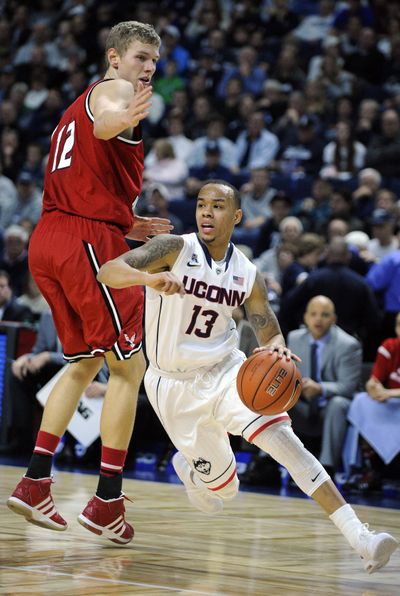 Connecticut’s Shabazz Napier drives past EWU’s Martin Seiferth during first-half play. (Associated Press)