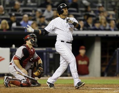 Robinson Cano watches his fourth-inning, three-run home run in Yankees’ 4-2 win over Arizona. (Associated Press)