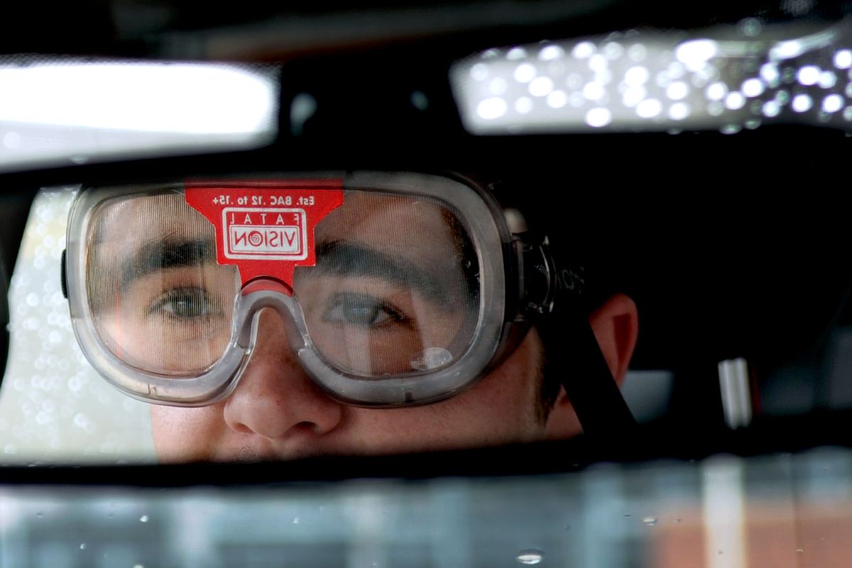 University High School junior Josh Denenny steers his way around the driving course while wearing Fatal Vision goggles at the high school on Wednesday. The goggles are designed to simulate drunken driving. (Kathy Plonka)