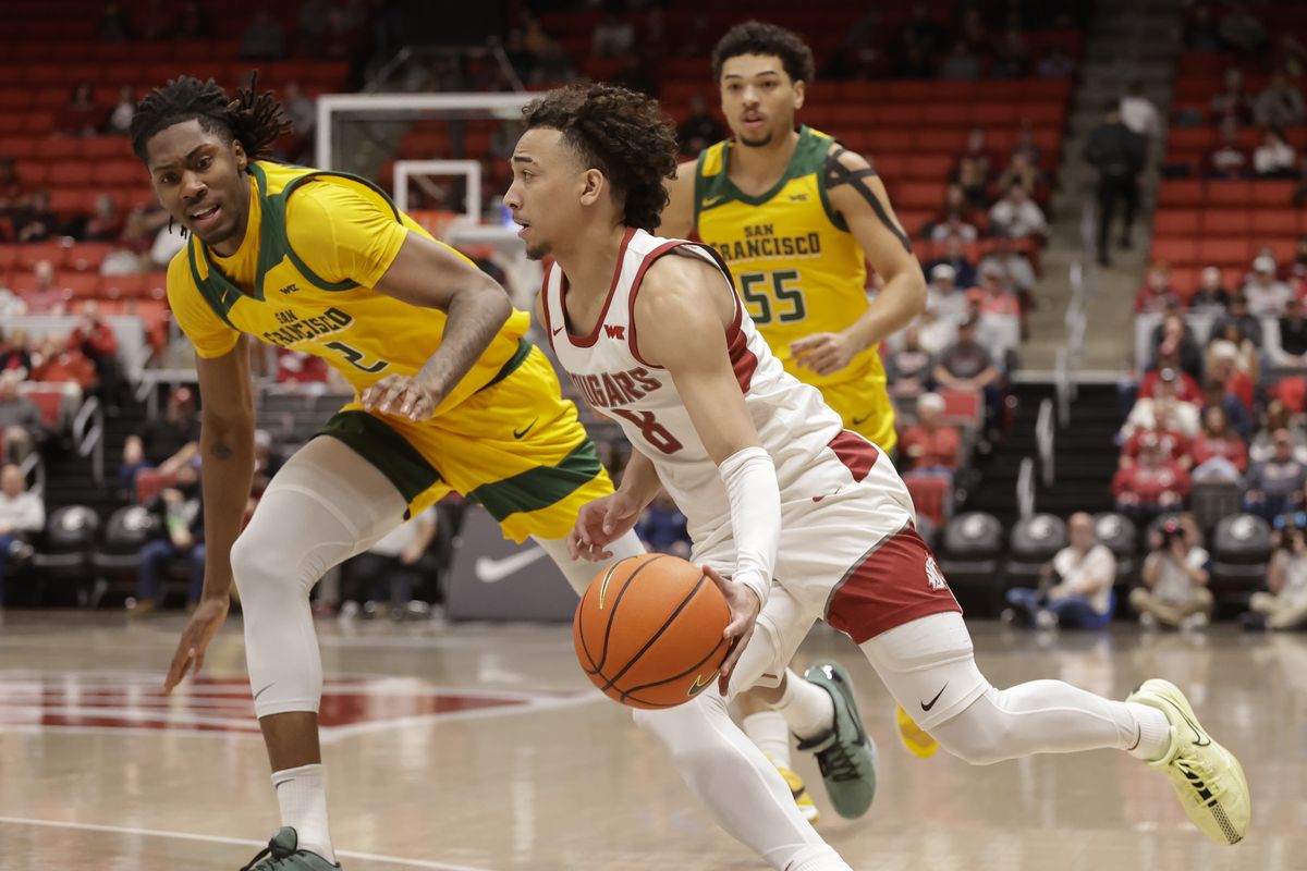 Washington State guard Nate Calmese (front) drives around San Francisco center Carlton Linguard Jr. (left) and guard Marcus Williams in the first half on Saturday, Jan. 4, 2025, at Beasley Coliseum in Pullman, Wash.  (Geoff Crimmins/For The Spokesman-Review)