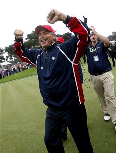 United States captain Fred Couples celebrates after U.S. team player Tiger Woods won his singles match to retain the Presidents Cup at Harding Park Golf Course Sunday, Oct. 11, 2009, in San Francisco. (Jeff Chiu / AP Photos)