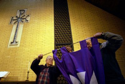 
Jake Mauk, left, and Allen Sherrodd put up a new banner in the worship sanctuary at Spokane Valley United Methodist Church. On Sunday the church will celebrate its 100th anniversary with a special 10 a.m. service that will feature an address by Bishop Edward W. Paup.
 (Liz Kishimoto / The Spokesman-Review)