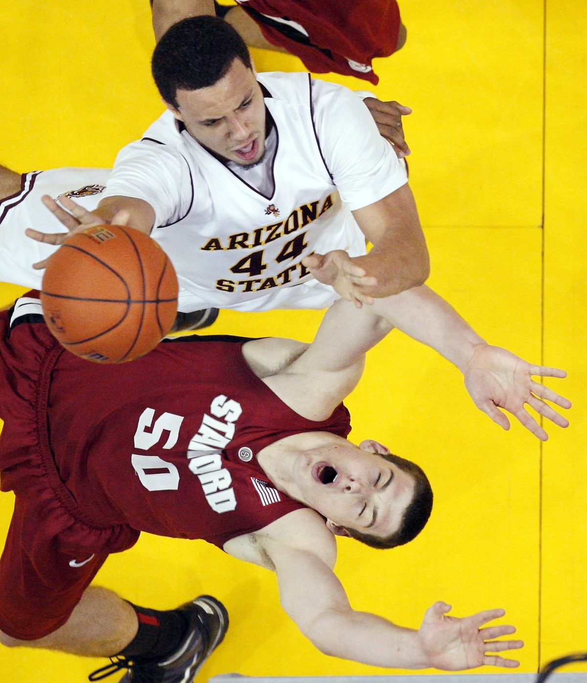 Arizona State’s Jerren Shipp, top, knocks over Stanford’s Jack Trotter as he goes up for a shot.  (Associated Press)