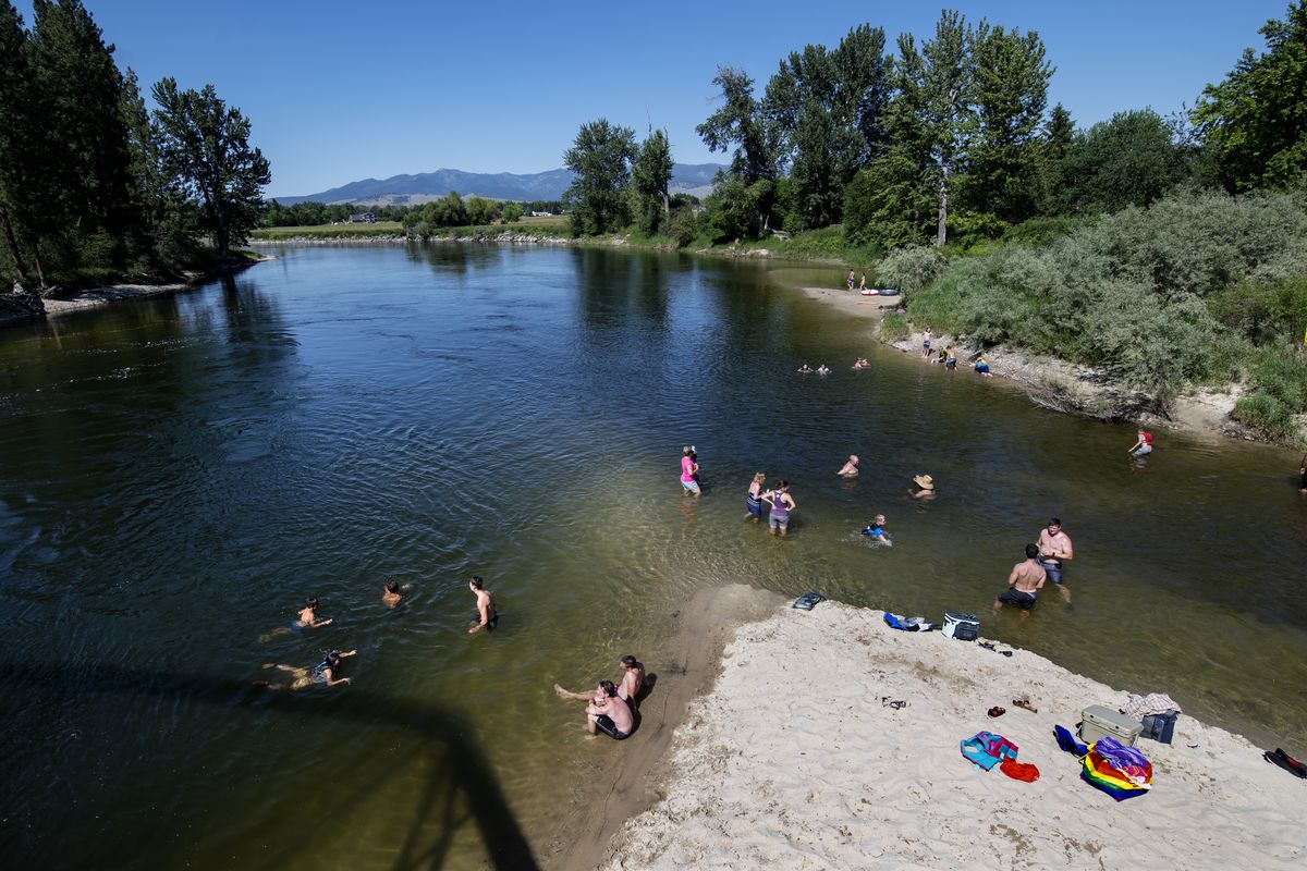 Missoulians cool off June 30 in the Bitterroot River as temperatures crested 100 degrees Fahrenheit in Missoula, Mont.  (Tommy Martino)