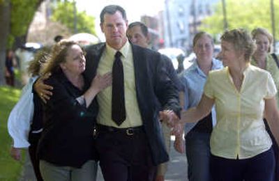 
Washington State Patrol Trooper Mark Haas leaves the Spokane County Courthouse  with friends and family Thursday after being acquitted. 
 (Dan Pelle / The Spokesman-Review)