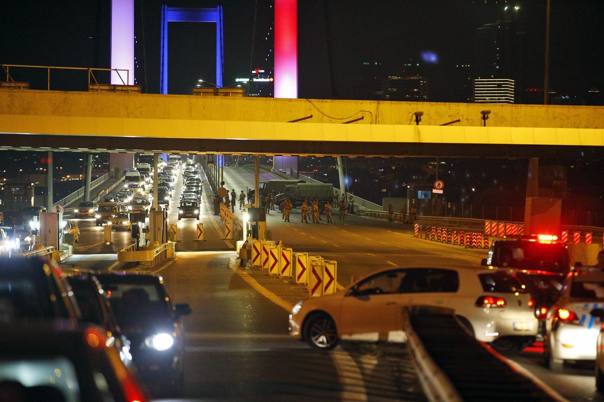 Turkish soldiers block Istanbul’s iconic Bosporus Bridge on Friday, July 15, 2016, lit in the colours of the French flag in solidarity with the victims of Thursday’s attack in Nice, France. A group within Turkey’s military has engaged in what appeared to be an attempted coup, the prime minister said, with military jets flying over the capital and reports of vehicles blocking two major bridges in Istanbul. Prime Minister Binali Yildirim told NTV television: “it is correct that there was an attempt,” when asked if there was a coup. (Emrah Gurel / Associated Press)