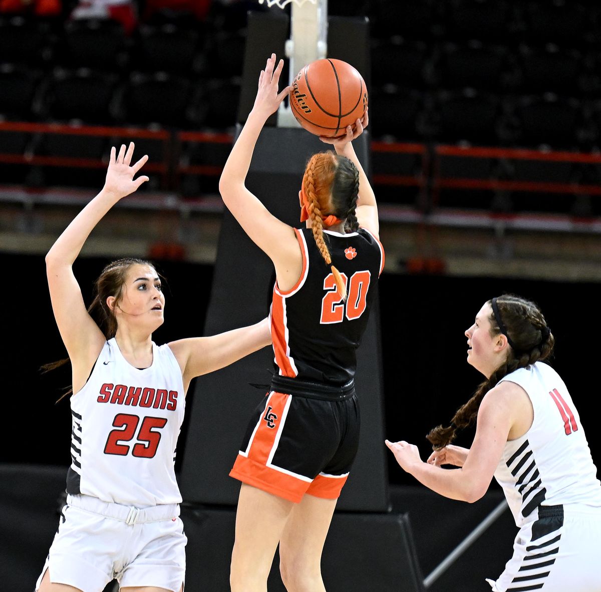 Lewis and Clark Ruby Shaw, center, shoots the ball over defender Ferris’ Maia Siemers during the first half of the Rubber Chicken high school basketball game Jan. 10 at the Spokane Arena.  (COLIN MULVANY/THE SPOKESMAN-REVIEW)