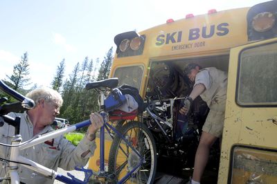 Ed White, left, and Dallas Ward, right, load bikes into the shuttle bus that carries cyclists from the end of the Route of the Hiawatha back to the start. (File / The Spokesman-Review)