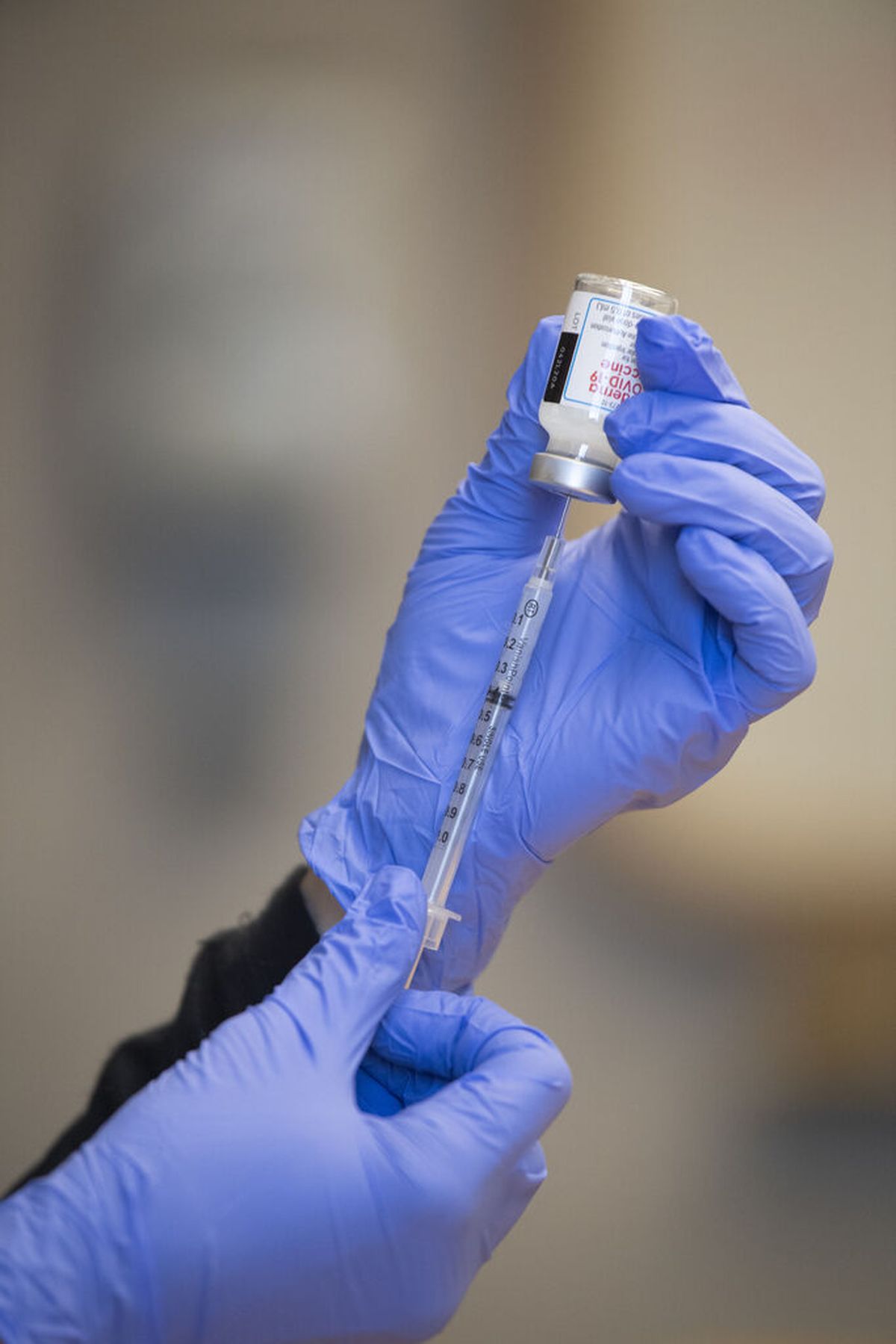 A health worker prepares a COVID-19 vaccine in Spokane.   (Jesse Tinsley/The Spokesman-Review)