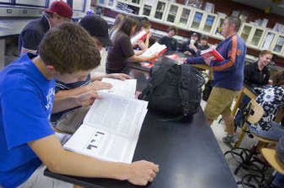
North Central High School sophomores Adam Reid, front,  and Brian Green read their published research June 13. 
 (Photos by CHRISTOPHER ANDERSON / The Spokesman-Review)