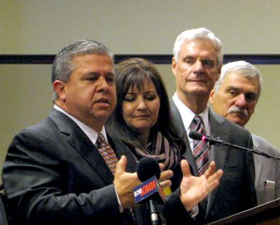 Idaho state schools chief Tom Luna, left, announces he won’t seek re-election. He is joined by, from left, his wife, Cindy, Idaho Senate President Pro-Tem Brent Hill and Senate Education Chairman John Goedde, of Coeur d’Alene, for the announcement. (Betsy Z. Russell)