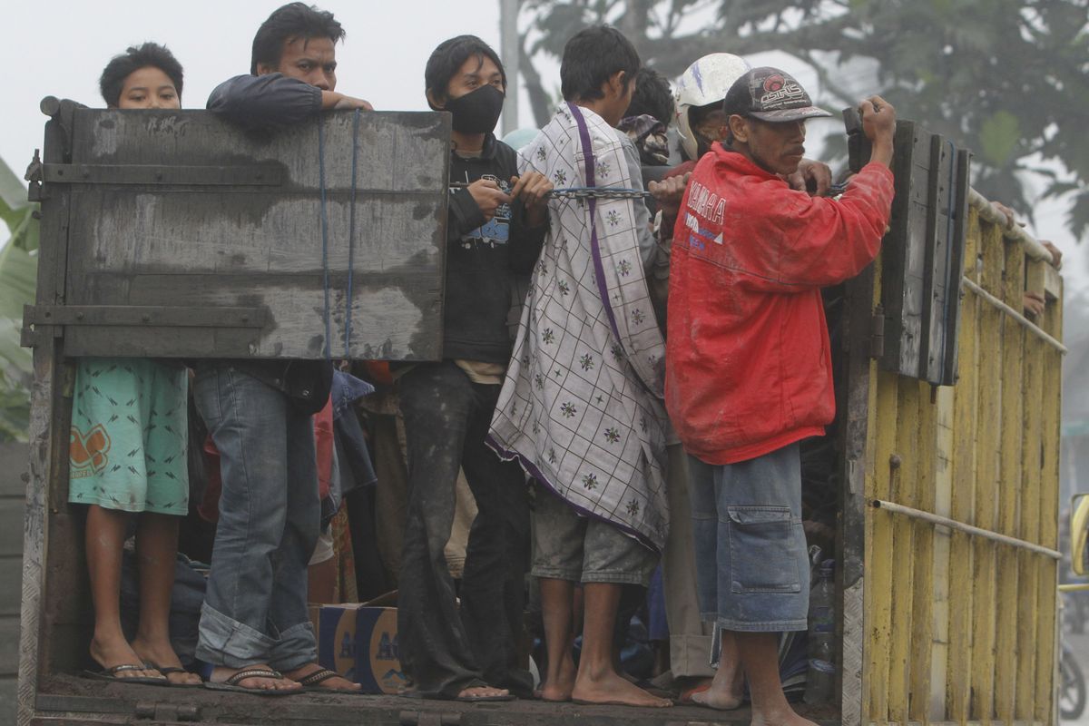 Villagers ride on a truck as they flee  their homes following another eruption of Mount Merapi, in Klaten, Indonesia, today.  (Associated Press)