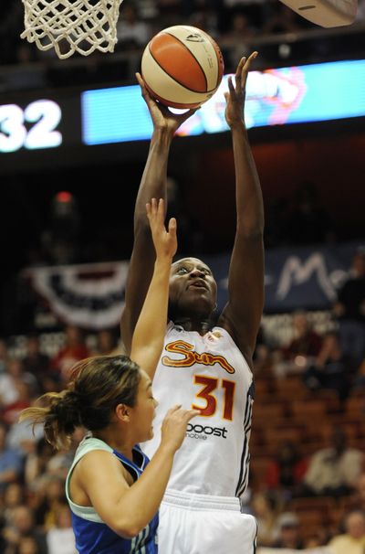 Connecticut’s Tina Charles, shooting over New York’s Leilani Mitchell, scored 17 points and had four blocks in the Sun’s victory. (Associated Press)