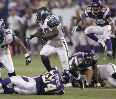 Seahawks running back Maurice Morris tears through Vikings defenders.  (Associated Press / The Spokesman-Review)