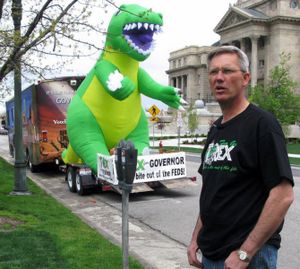 In this 2010 SR photo by Betsy Russell, Rex Rammell campaigns for governor of Idaho with the help of a giant inflatable T-Rex dinosaur and a decorated RV.