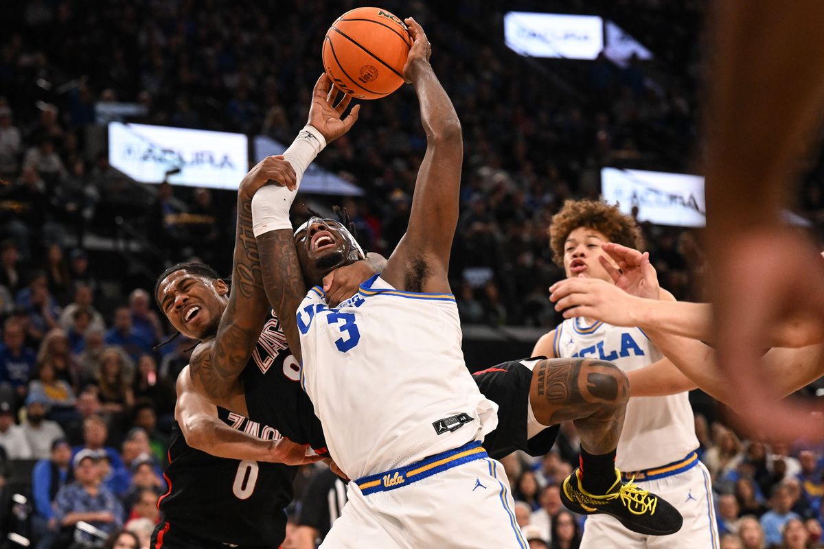 Gonzaga Bulldogs guard Khalif Battle (99) wraps up UCLA Bruins guard Eric Dailey Jr. (3) on a play that resulted in Battle being called for a Flagrant Foul 2 and ejected from the game during the first half of a college basketball game on Saturday, Dec. 28, 2024, at the Intuit Dome in Inglewood, Calif.  (Tyler Tjomsland/The Spokesman-Review)