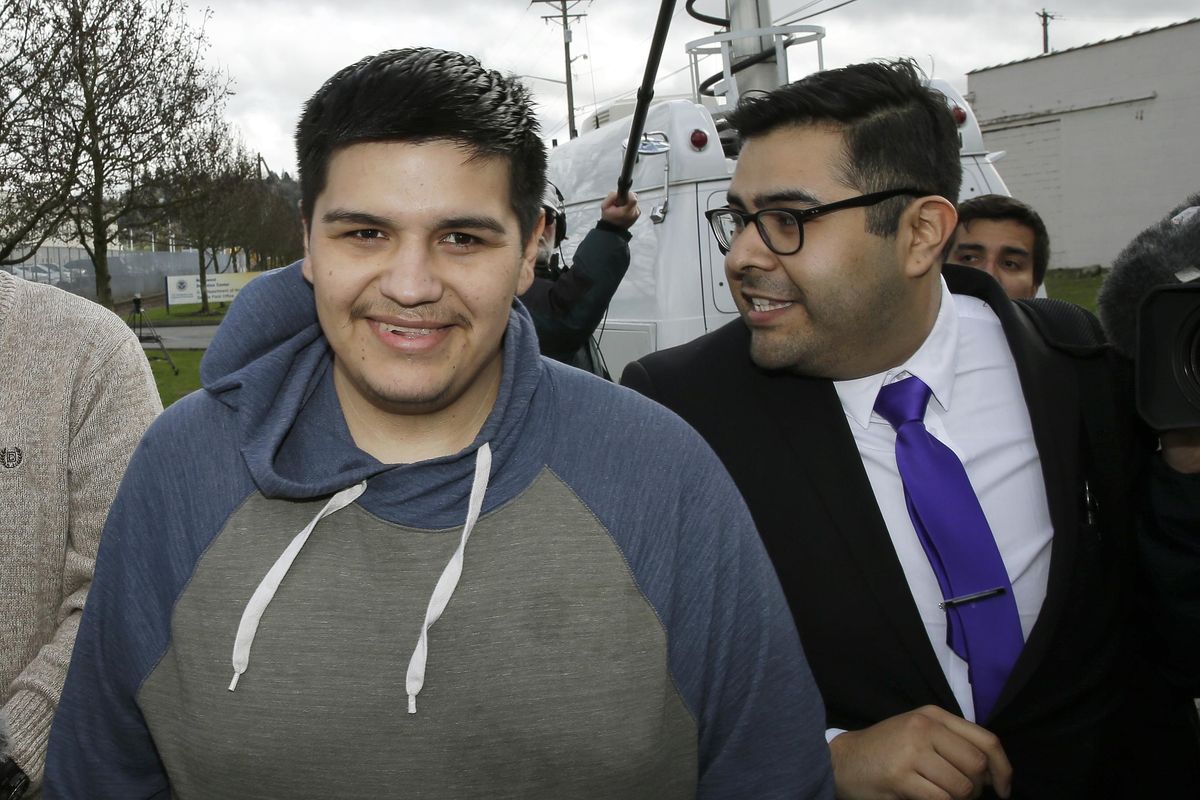 Daniel Ramirez Medina, left, walks with with his attorney, Luis Cortes, right, after Ramirez was freed from custody at the Northwest Detention Center in Tacoma, Wash., Wednesday, March 29, 2017. (Ted S. Warren / Associated Press)