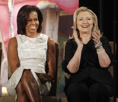 FILE - In this March 8, 2012, file photo, then-Secretary of State Hillary Clinton and first lady Michelle Obama attend the 2012 International Women of Courage Awards at the State Department in Washington. (Charles Dharapak / AP)