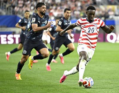 The United States’ Folarin Balogun pushes the ball up the field during the second half of a FIFA World Cup Group D soccer match against Paraguay on June 12 at Los Angeles Stadium in Inglewood, Calif.  (Tribune News Service)