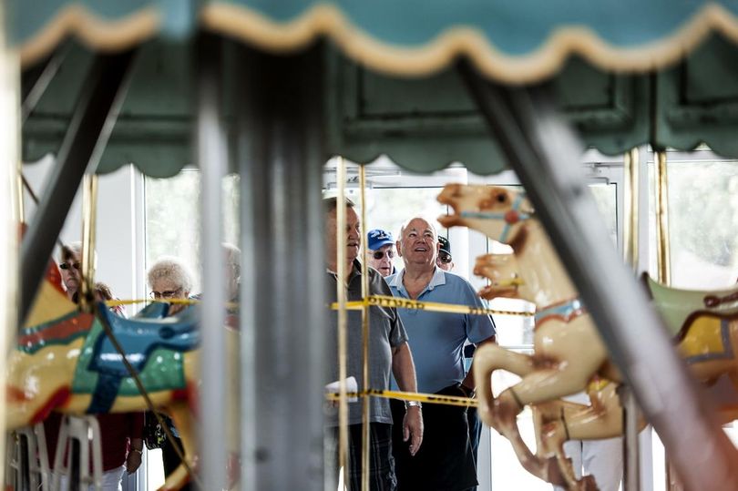 “I remember riding my bike here when I was a kid,” said Wally Adams, center, blue shirt, as he visited Coeur d’Alene’s Historic Playland Pier Carousel along with fellow members of Coeur d’Alene High School’s class of 1959 on Tuesday, June 6, 2017. The grand opening is Friday, June 9, 2017. (Kathy Plonka / The Spokesman-Review)