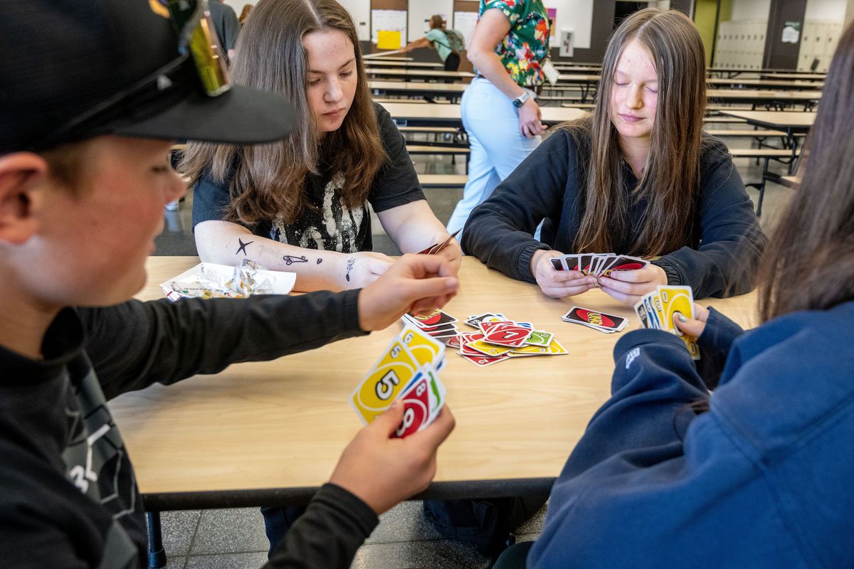 Students Tyler Prosser, left, Zoe Jackson, Puniyo Hoard and Ofelia Gutierrez play Uno on their lunch break in 2024. Salk administrators banned cellphone use during school hours and have seen a huge improvement in how students interact with each other without the distraction of a cellphones. (Colin Mulvany/The Spokesman-Review)