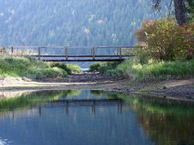 
A small footbridge carries hikers to the small peninsula that forms the hook in Buttonhook Bay at Farragut State Park. 
 (Mike Kincaid / The Spokesman-Review)