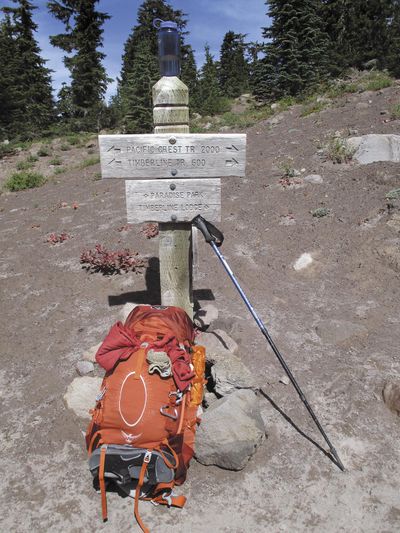 A sign shows where the Timberline Trail and Pacific Crest Trail intersect and combine for several miles on the west slope of Mount Hood near Government Camp, Ore., Sept. 20, 2013. Backpackers frantically tried to save the life of one of the two young Portland women who apparently fell to their deaths Thursday, Aug. 10, 2017, at Mount Hood, a series of calls to Clackamas County 911 show. (Bennett Hall / Associated Press)