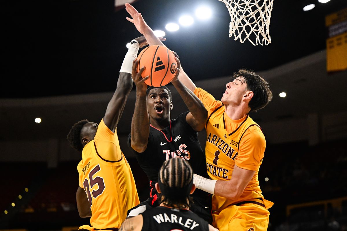 Gonzaga Bulldogs guard Tyon Grant-Foster (7) gets the ball around Arizona State Sun Devils center Mor Massamba Diop (35) and forward Santiago Trouet (1) in the paint for two points during the second half of a college basketball game on Friday, Nov 14, 2025, at Desert Financial Arena in Tempe, AZ. The Gonzaga Bulldogs won the game 77-65.  (Tyler Tjomsland/The Spokesman-Review)