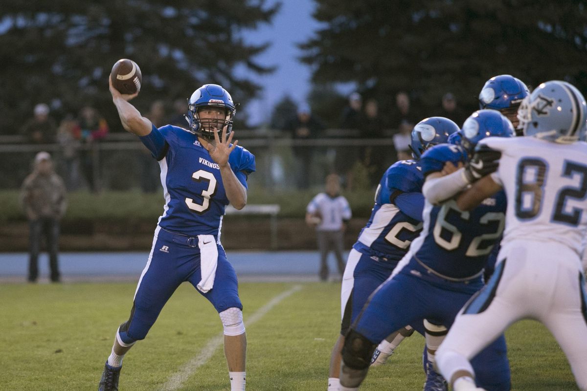 Coeur d'Alene's Cole Yankoff gets a pass off in the first quarter against Central Valley Friday night at Coeur d'Alene High School. (BRUCE TWITCHELL)