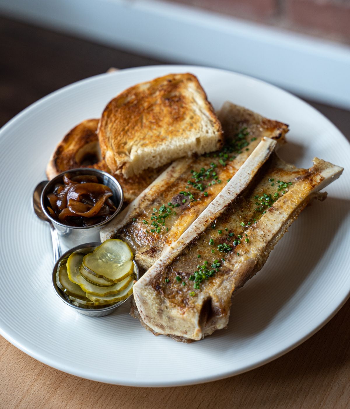 After eating bone marrow on toast, customers can use the bone as a luge for sherry at Wooden City in downtown Spokane.  (Jon Green)