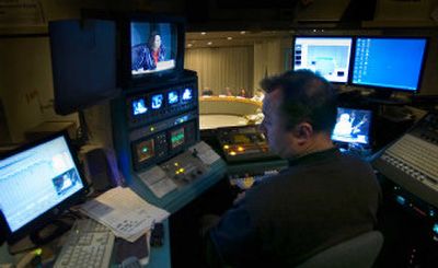 
High above the Spokane City Council Chambers, CityCable 5 video producer Jaye Nordling broadcasts a city planning meeting being run by Candace Mumm, top screen, Wednesday. 
 (Christopher Anderson/ / The Spokesman-Review)