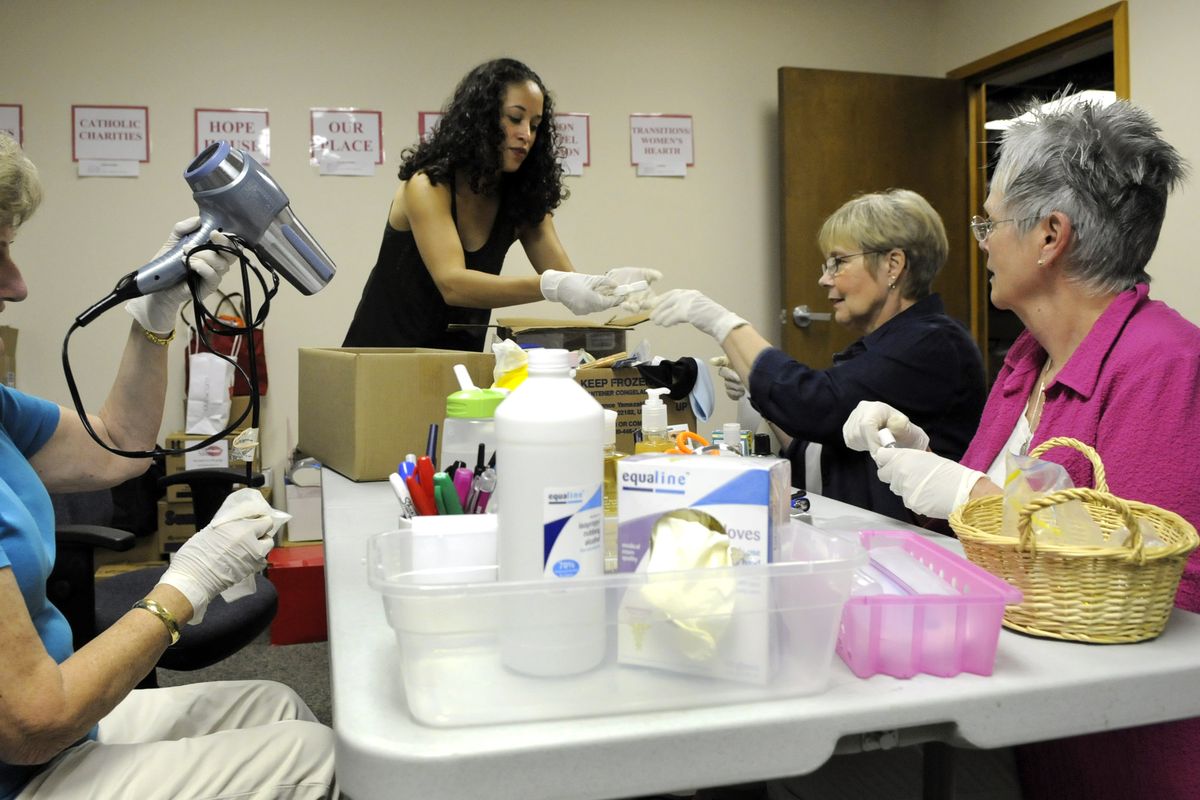 Susan Smith, 71, Jaime Johnson, 30, Renee Myrun, 67, and Mary Ann Hartsfield, 67, sanitize health and beauty products for Project Beauty Share in downtown Spokane, Wa. (Dan Pelle / The Spokesman-Review)
