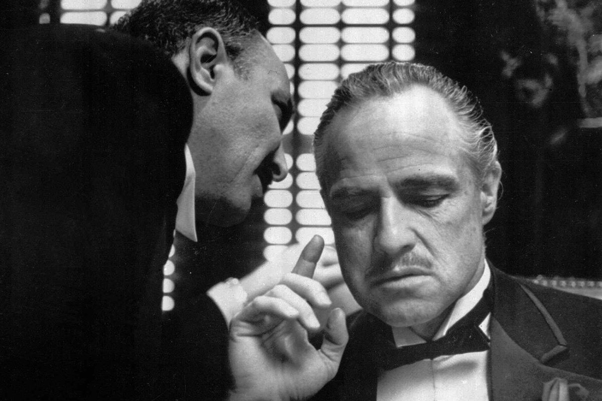 Bonasera, portrayed by Frank Puglia, asks Don Corleone, portrayed by Marlon Brando, at right, for a favor in a scene from the 1972 movie “The Godfather.”  (HO)