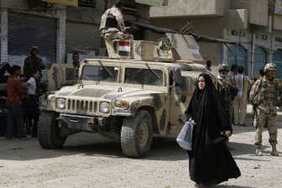 
Iraqi soldiers with a U.S.-made Humvee stand guard in the Shiite enclave of Sadr City in Baghdad on Tuesday. Associated Press
 (Associated Press / The Spokesman-Review)