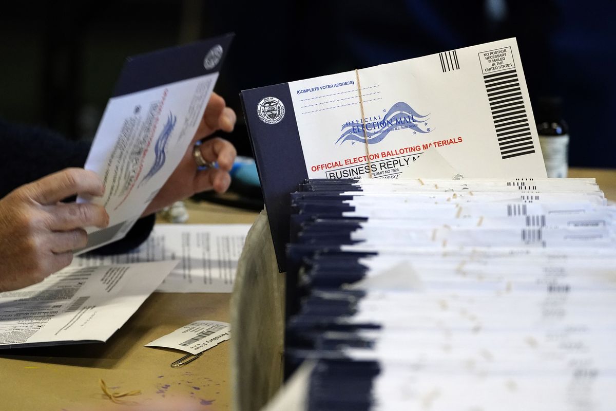 In this Nov. 4, 2020 photo, Chester County, Pa. election workers process mail-in and absentee ballots at West Chester University in West Chester. Democrats plan to move quickly on one of the first bills of the new Congress, which would set federal election standards. The For the People Act would require states to offer early voting, same-day registration and the option of absentee voting for all registered voters.  (Matt Slocum)