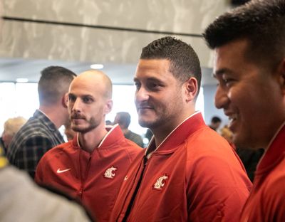Michael Ghobrial (center) converses with other assistant coaches following Washington State University head football coach Nick Rolovich's introductory press conference at the university on Jan. 16, 2020 in Pullman, Wash.  (Libby Kamrowski / The Spokesman-Review)
