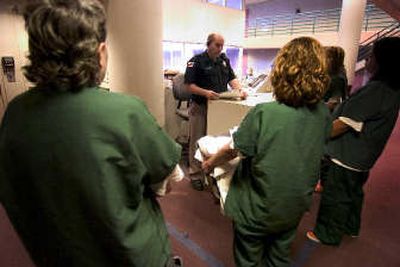 
Corrections officer Michael Jolstead checks in new female inmates at the Spokane County Jail, which is facing a year-end budget deficit of $1.5 million. 
 (Colin Mulvany / The Spokesman-Review)