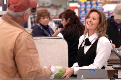 
Kelli Ormesher chats with customers as she scans items Friday at Super 1 Foods in Coeur d'Alene. The Idaho Legislature this year will face the question of reducing or eliminating the sales tax on groceries or offering  relief in the form of a increased tax credit.
 (Jesse Tinsley / The Spokesman-Review)