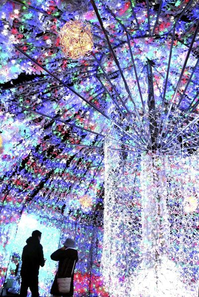 Tourists enjoy an illuminated tunnel at Toyako Onsen hot springs resort.  (Japan News-Yomiuri/Japan News-Yomiuri)