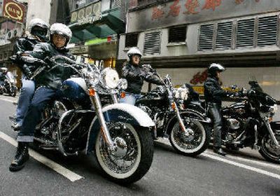 
Hong Kong Harley riders ride their motorcycles in the streets of Hong Kong.  
 (Associated Press / The Spokesman-Review)