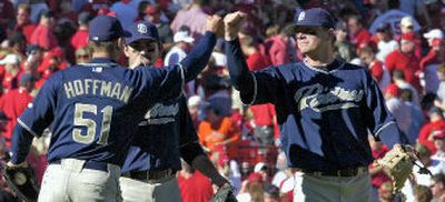 
Geoff Blum, right, Adrian Gonzalez bump fists with Trevor Hoffman.
 (Associated Press / The Spokesman-Review)