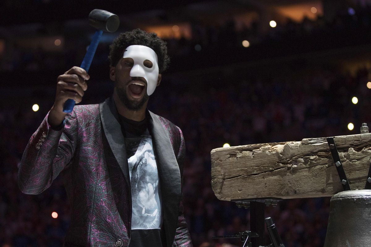 Philadelphia 76ers’ Joel Embiid comes out in a “Phantom of the Opera” mask as he rings a Liberty Bell replica before Game 1 of the team’s first-round NBA basketball playoff series against the Miami Heat, Saturday, April 14, 2018, in Philadelphia. (Chris Szagola / Associated Press)