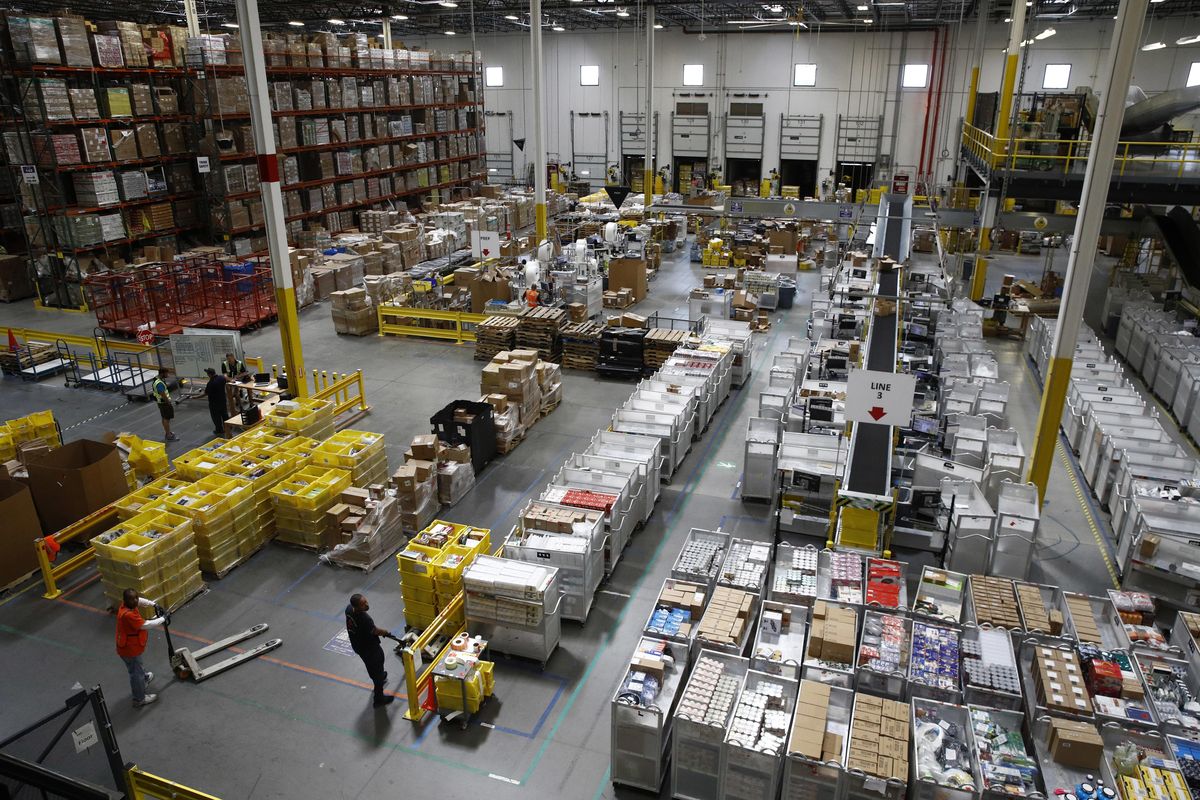 Workers prepare to move products at an Amazon fulfillment center in Baltimore. (Patrick Semansky / AP)