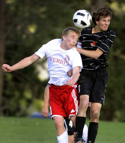 Ferris' Clayton Paull, left, and Lewis and Clark's Dane Lennon compete for ball. (Colin Mulvany)
