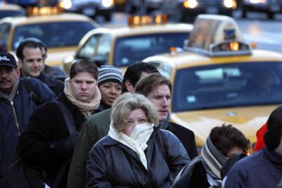 
New York City commuters wait in line to catch a taxi Tuesday. Subways and buses ground to a halt Tuesday morning in New York as transit workers walked off the job following days of acrimonious labor talks. 
 (Associated Press / The Spokesman-Review)