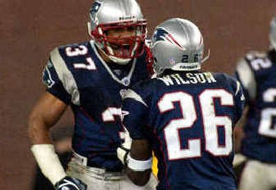 
New England's Rodney Harrison (37) and Eugene Wilson celebrate an unsuccessful fourth-down attempt by the Jets.
 (Associated Press / The Spokesman-Review)