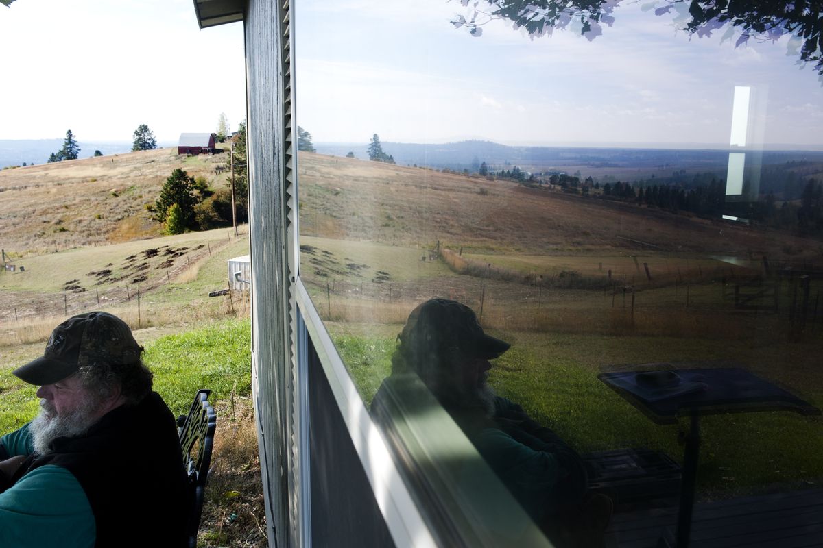 Bill Demers sits on the porch of his farmhouse Wednesday. He has three cows and a pasture with an intermittent stream running through it. Demers is upset about a recent state Supreme Court ruling that affirms the Department of Ecology’s ability to regulate cows in streams. (Tyler Tjomsland)
