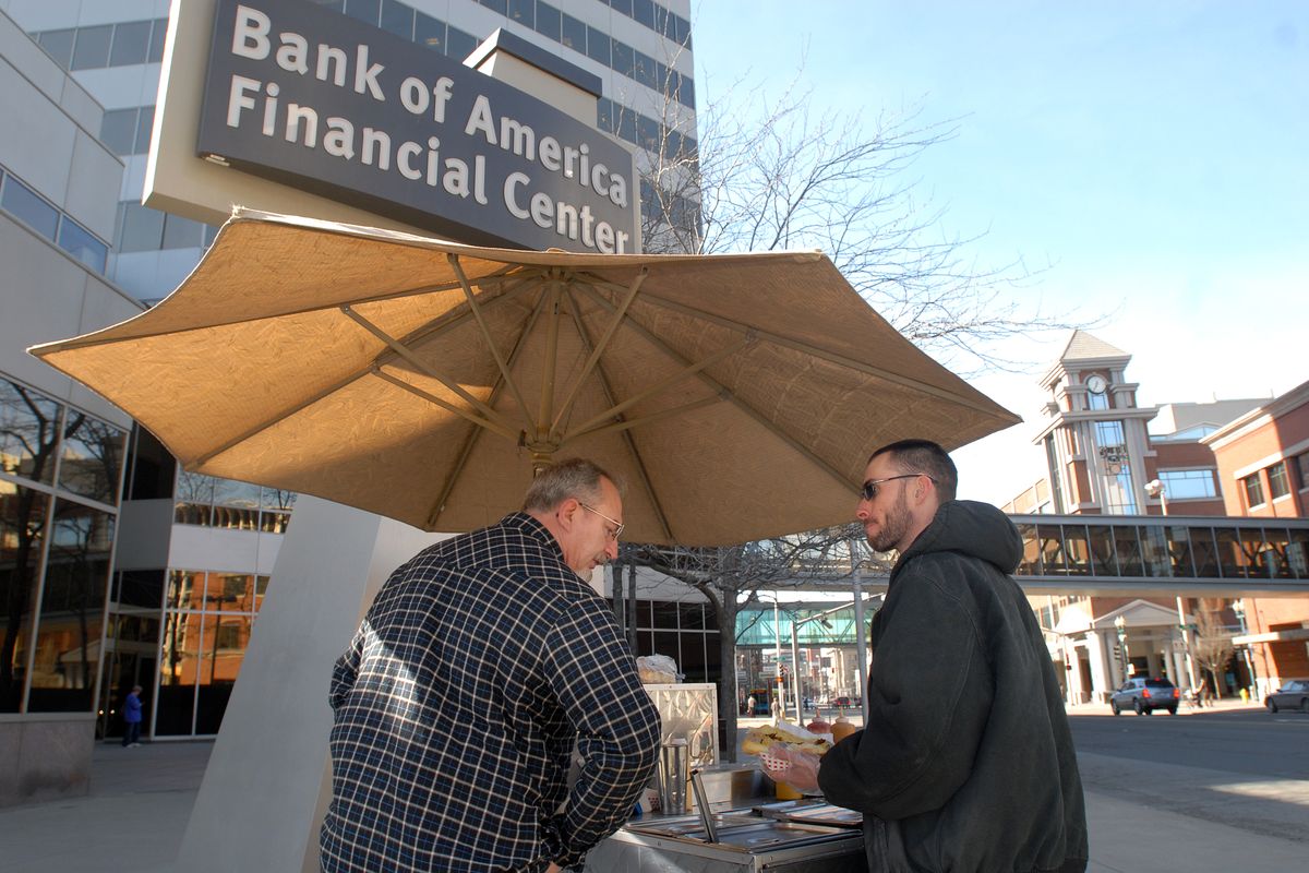 Hot dog vendor Chad Rattray, right, chatted with a customer outside the Bank of America building in downtown Spokane in 2008.  (Jesse Tinsley)